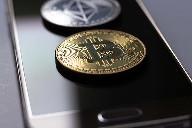 Image of physical bitcoin on phone